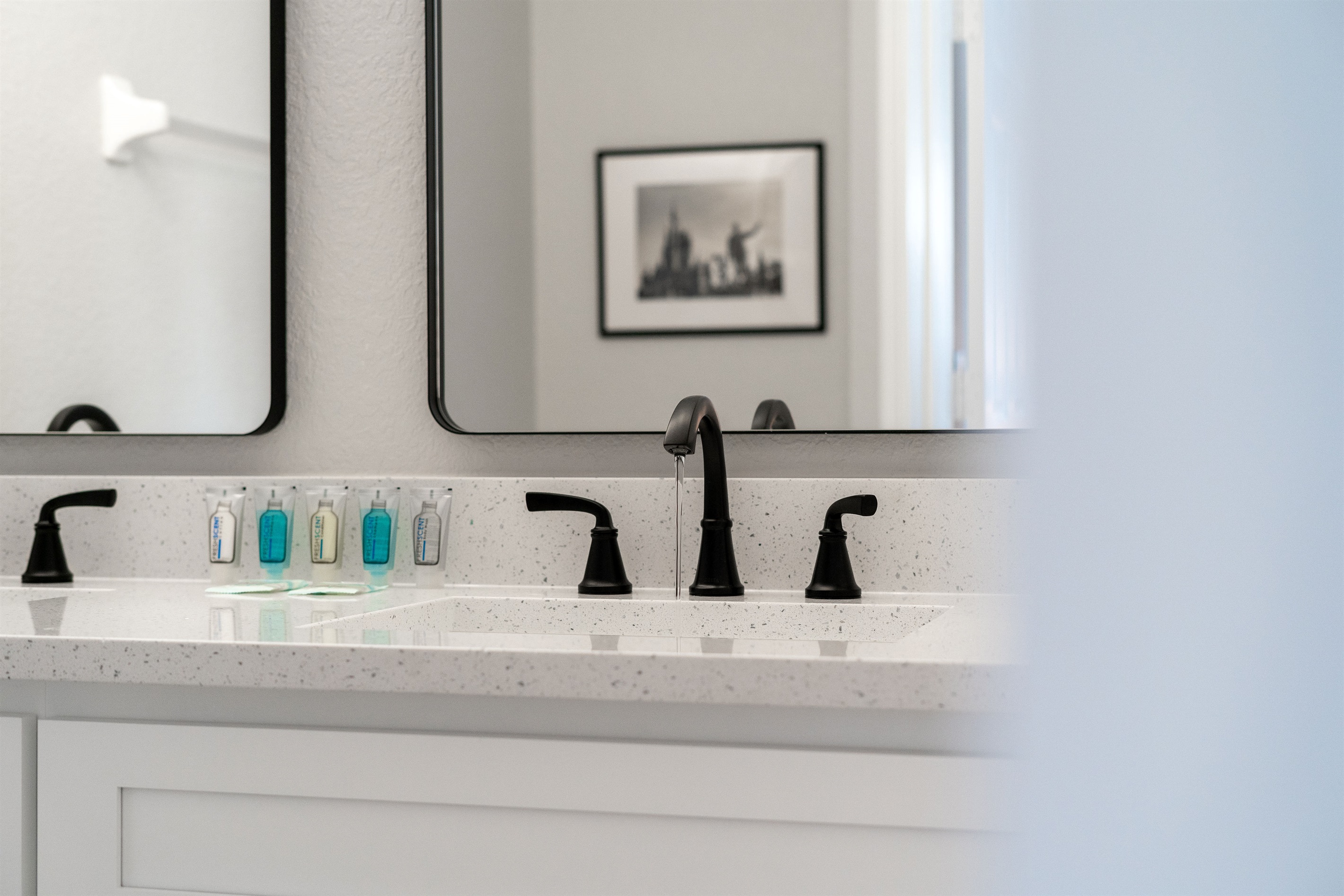 Primary bathroom with a large soaking tub, new cabinets, quartz counters, and double vanity sinks