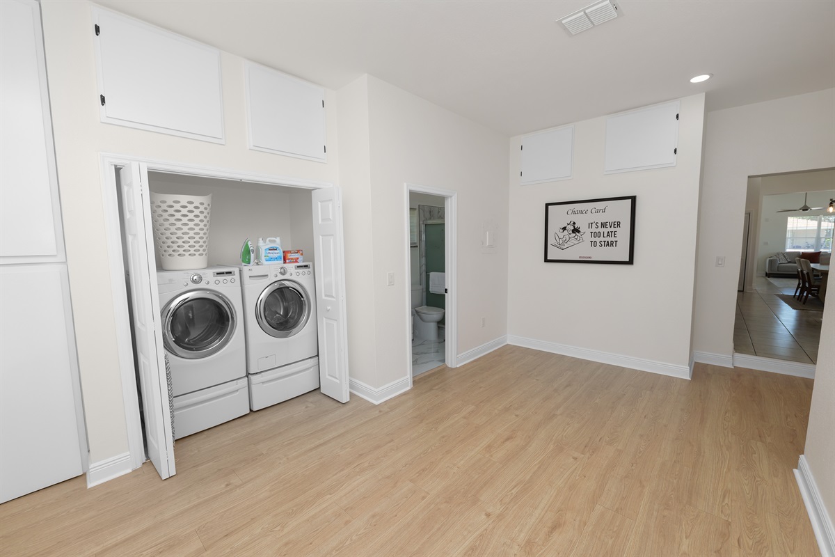 Tucked neatly behind folding doors, this laundry nook features a full-size washer and dryer, laundry basket, and essential supplies—ready for all your mid-trip refreshes.