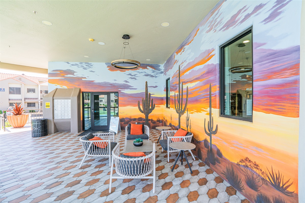 Vibrant courtyard with games, string lights, and lush green space for fun and relaxation.