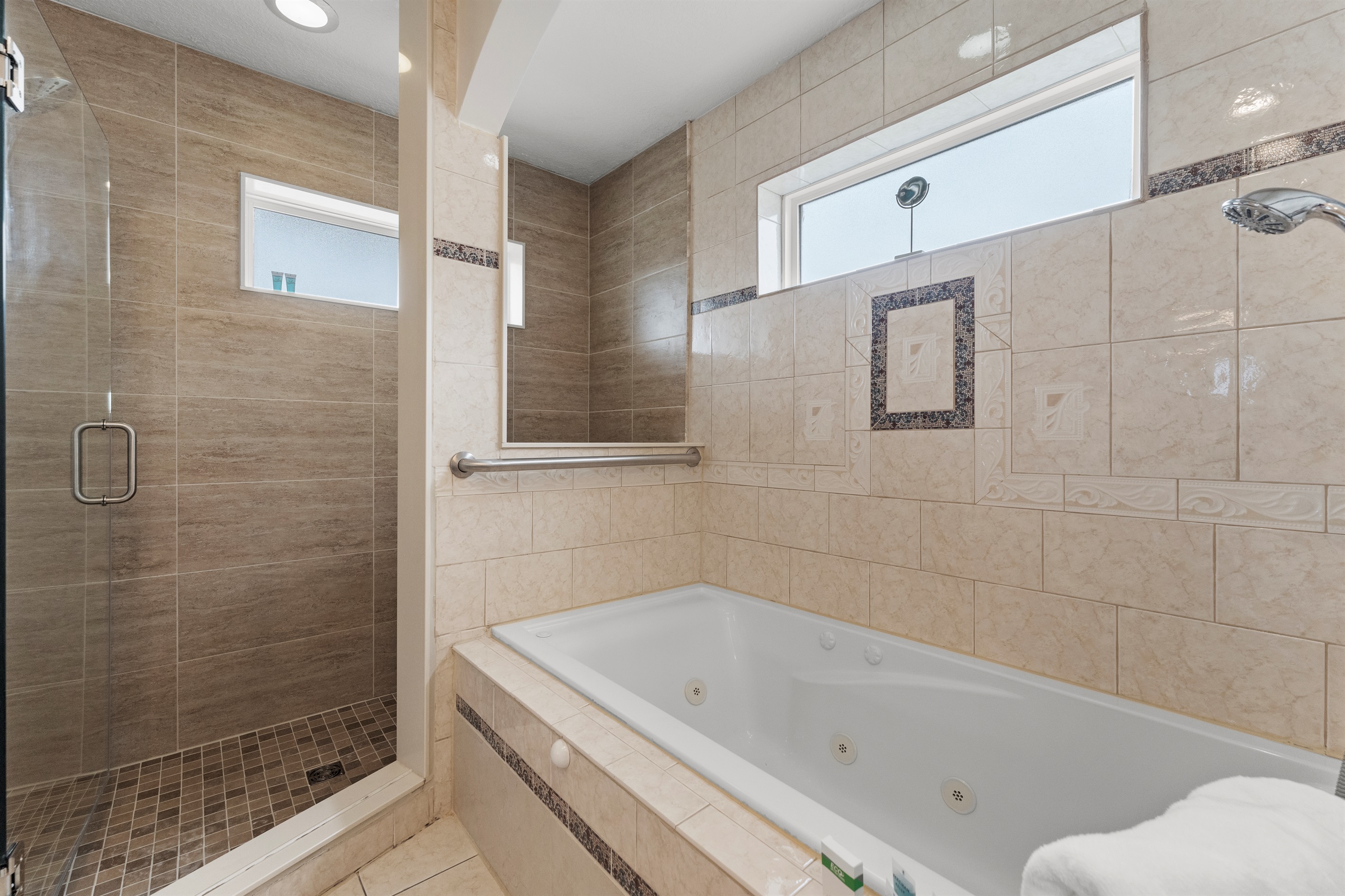 Gorgeous, roomy master ensuite bathroom with a walk-in shower featuring dual showerheads and a large soaking bathtub, perfect for relaxing at day's end.