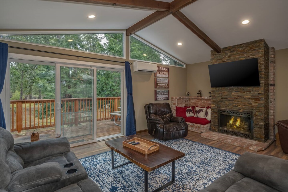 Upstairs living room with plenty of seating, view of the serene backyard, gas fireplace to keep you cozy and a cute little reading nook. 