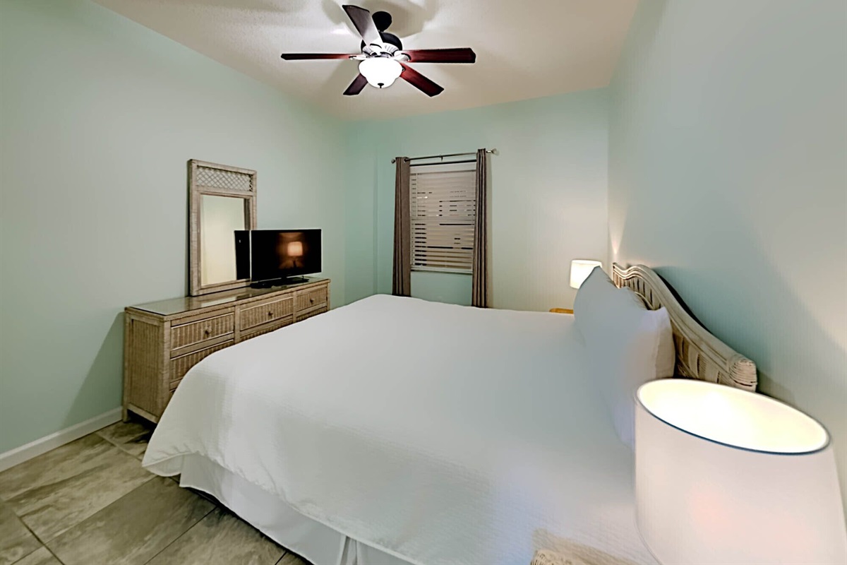 Master bedroom with king bed, smart TV, ceiling fan and ensuite bathroom