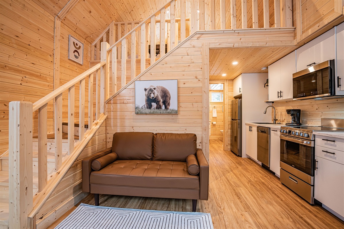 View of lower kitchen and sitting area, along with upper loft.