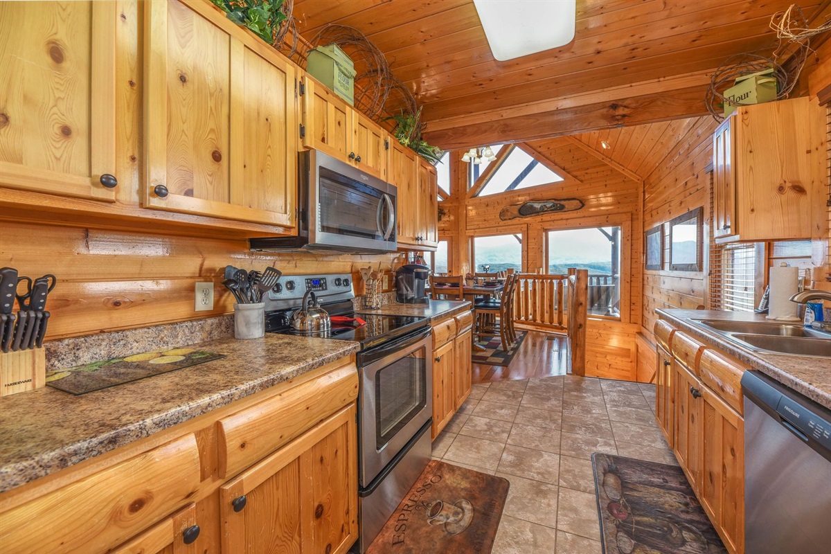 - Fully equipped kitchen with stainless appliances and rustic wood cabinetry   - Prepare home-style meals while enjoying mountain views through the dining area   - Perfect blend of cabin warmth and modern comfort for your Smoky Mountain stay