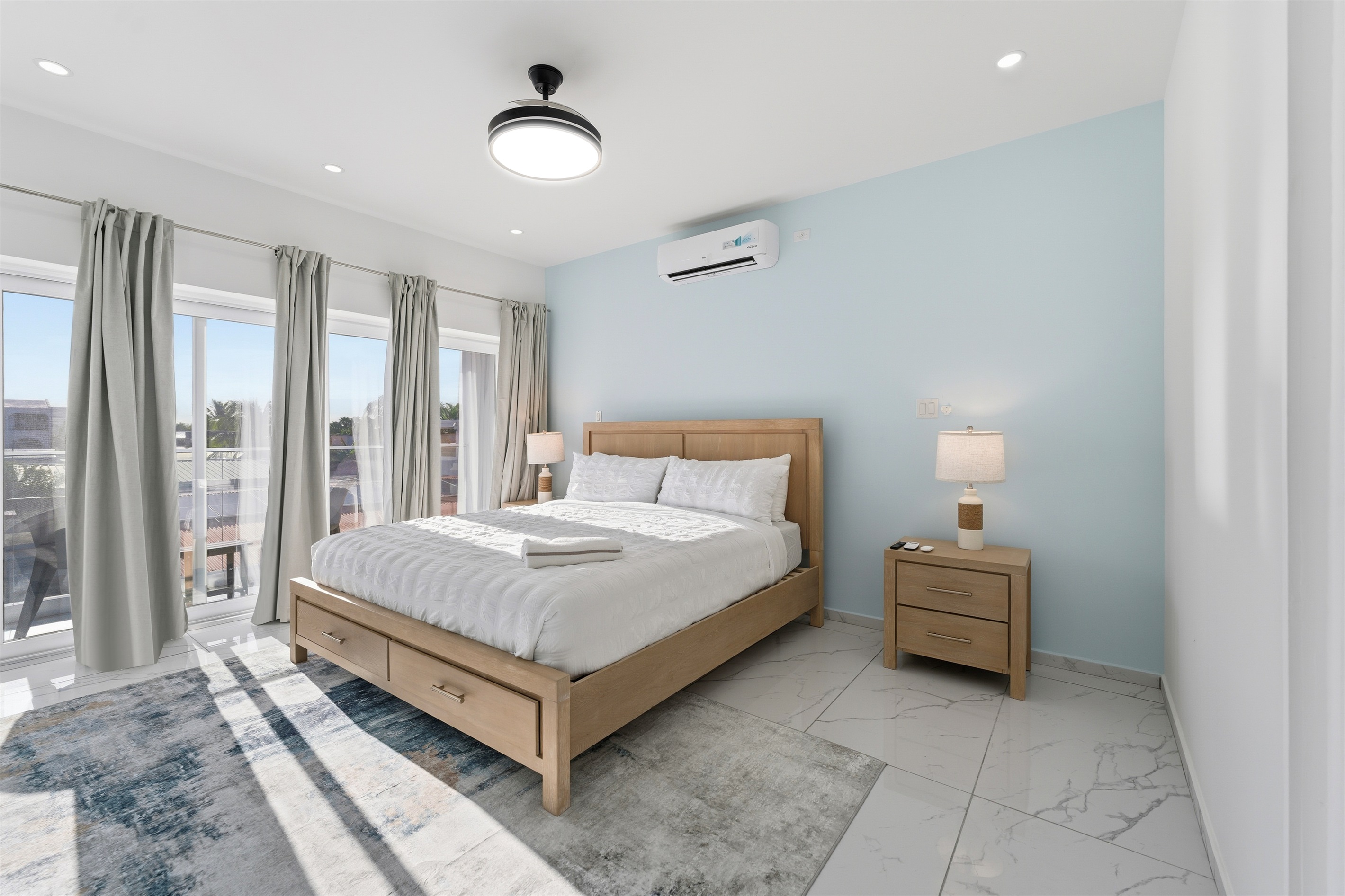 Primary Suite: A King-sized retreat with sky-blue accents and direct balcony access