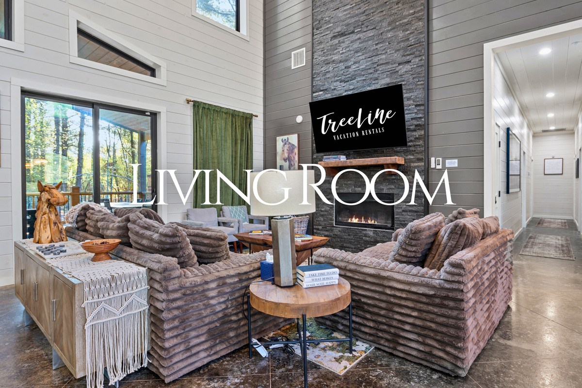 Vaulted ceilings, oversized windows, and comfortable seating create an inviting living space where everyone can relax together after a day of adventure.