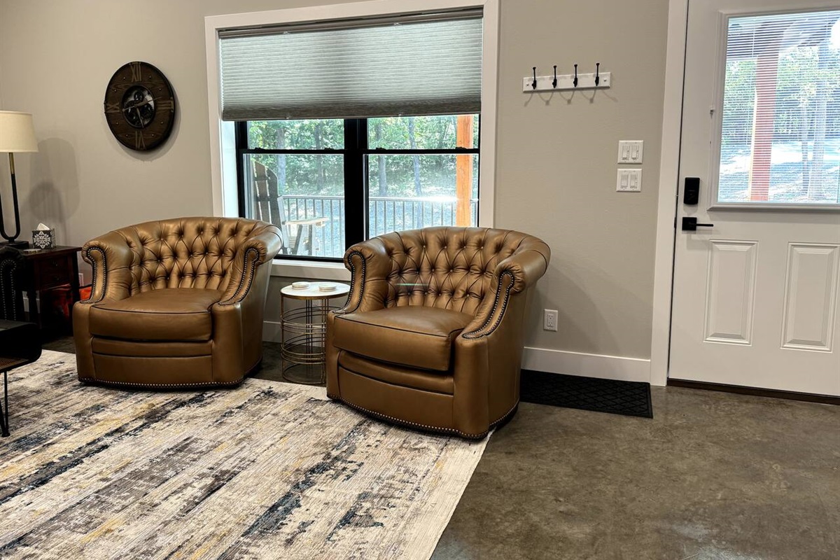 The main entrance into the living room. Sit in the leather swivel chairs facing the living room or turn and face the view outside the window.