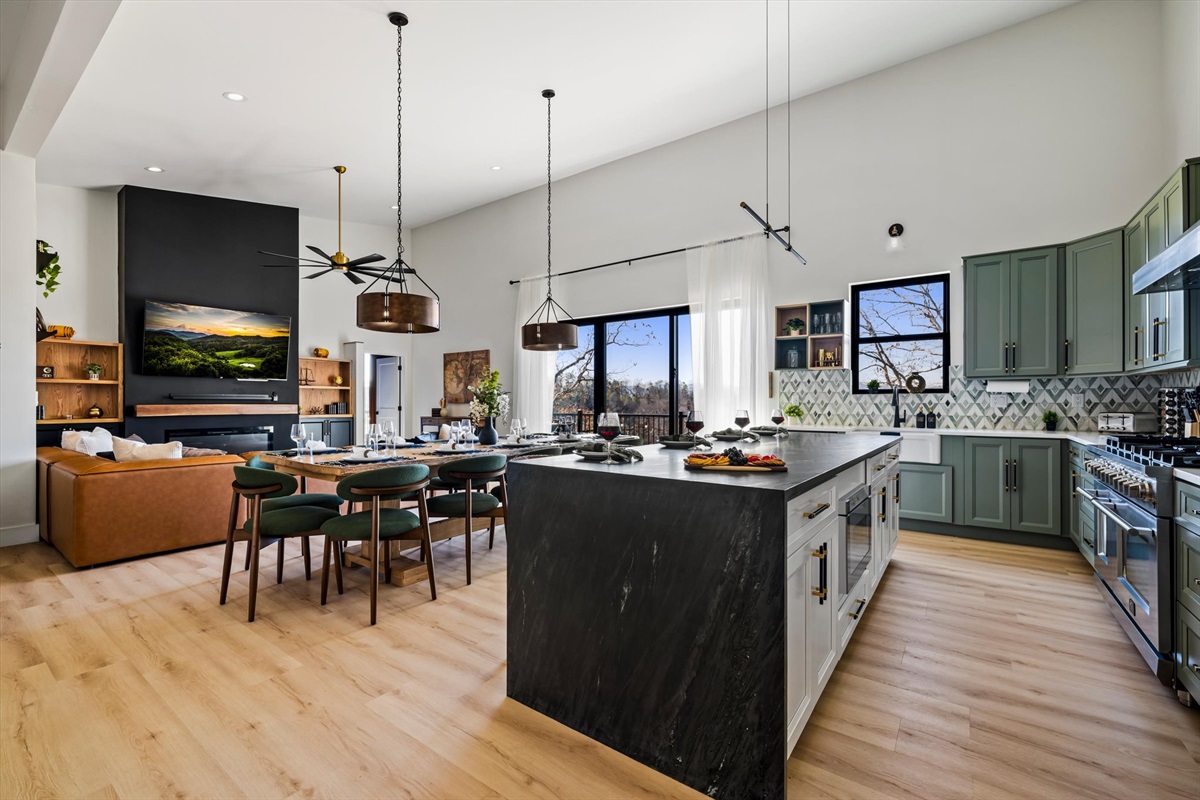 {Kitchen + Living Space}
A fully open-concept layout where everyone stays connected — oversized island seating, designer kitchen, and seamless flow into the living room for effortless group gatherings.