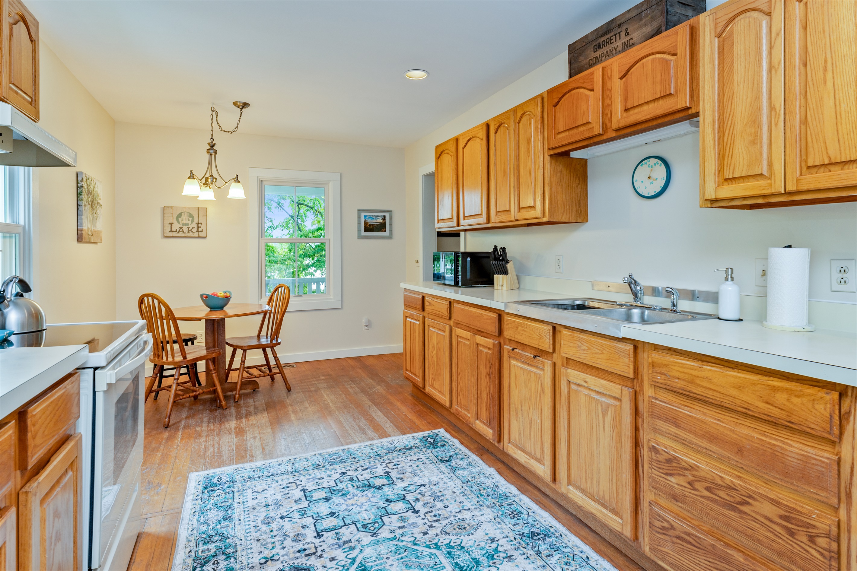 Bright and welcoming kitchen with warm wood cabinetry, modern appliances, and a cozy dining nook—perfect for morning coffee or casual meals.