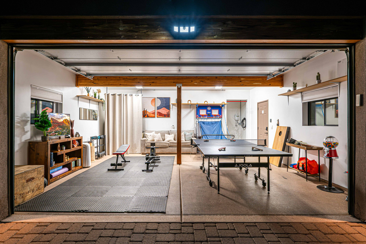 {Game Room + Gym} The garage doubles as a game and fitness space with ping pong, arcade basketball and workout equipment.