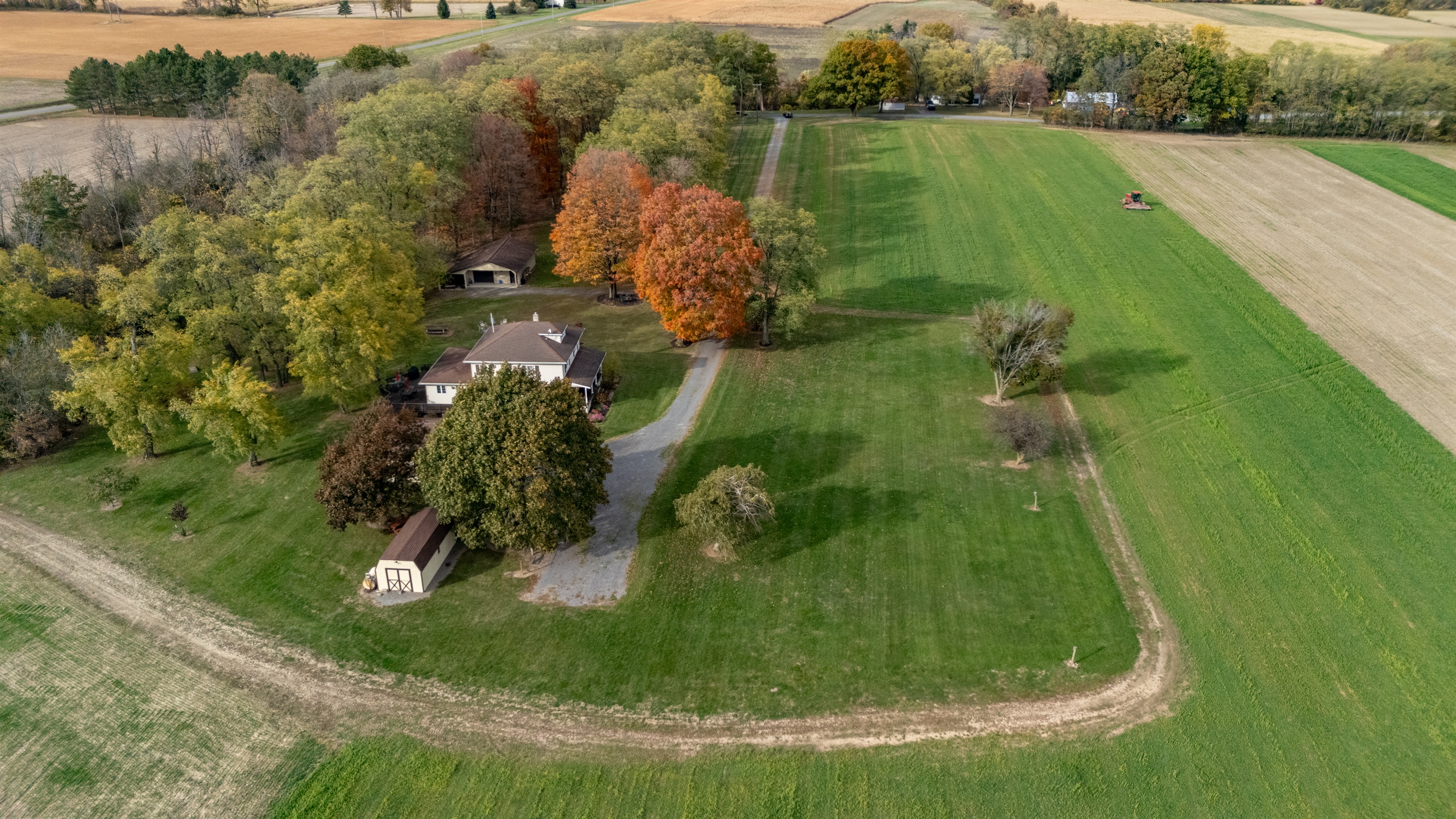 A charming farmhouse nestled among brilliant fall colors