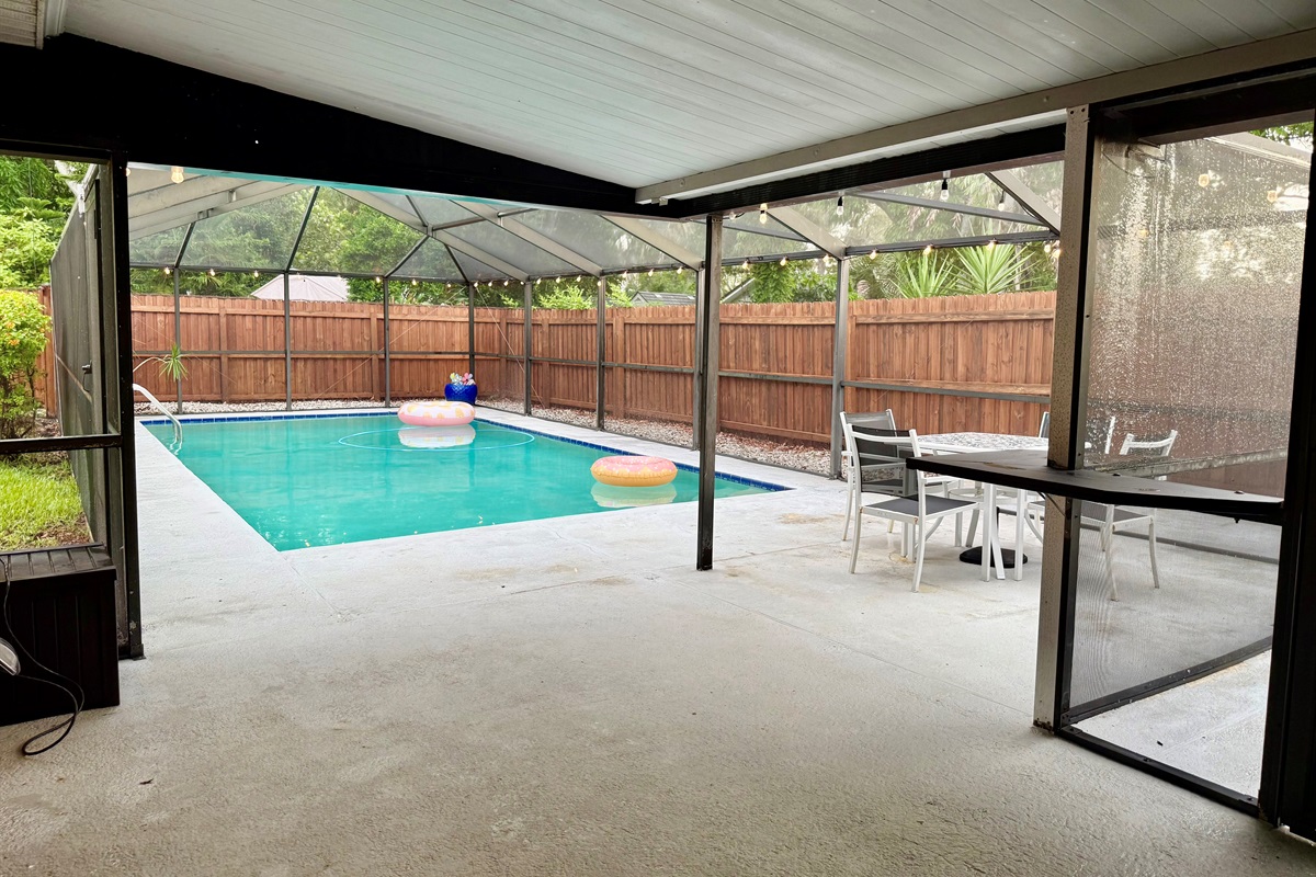 Gather around this stylish patio table for snacks or sunset drinks, all under the protection of a screened enclosure.