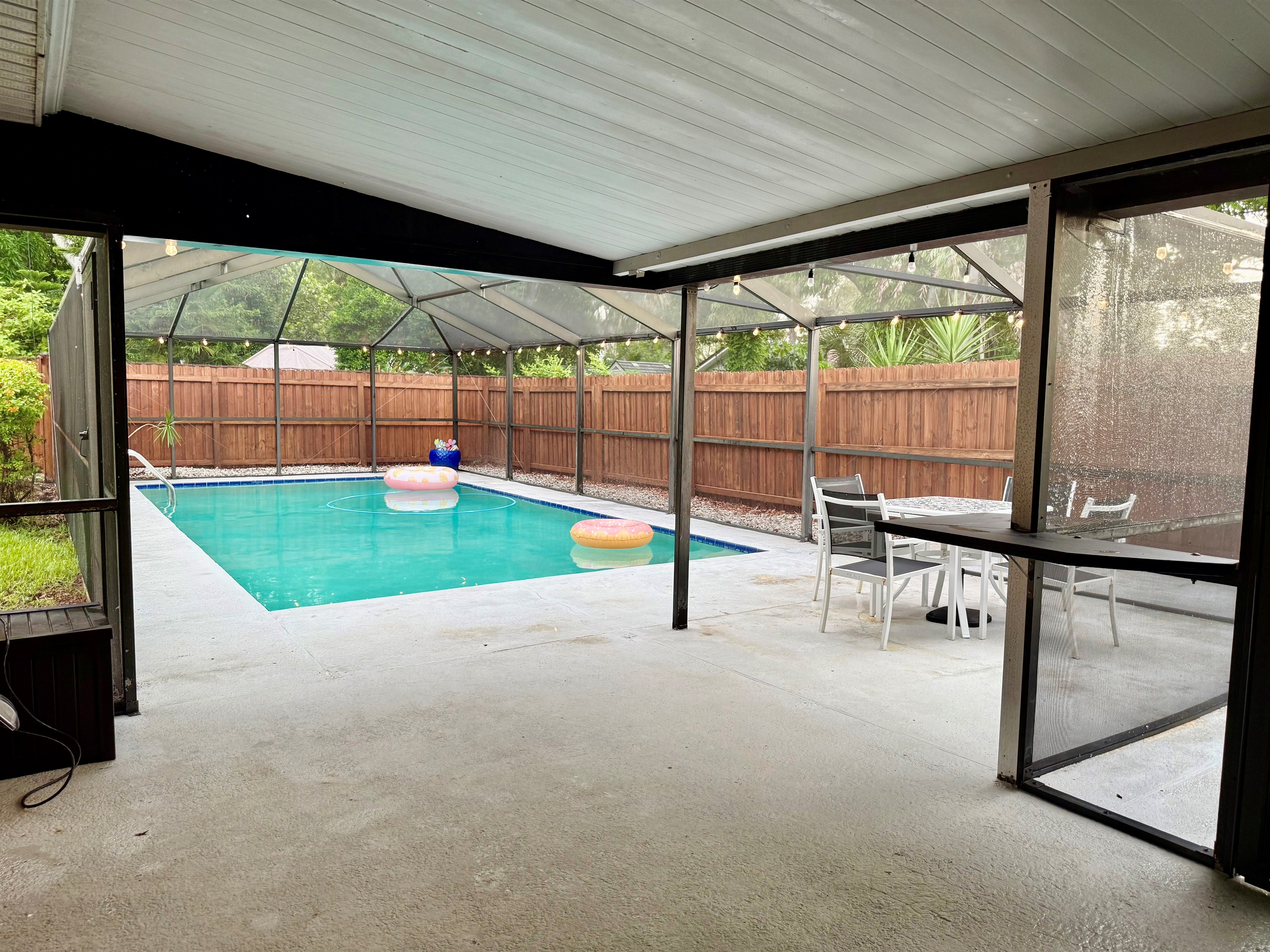 Gather around this stylish patio table for snacks or sunset drinks, all under the protection of a screened enclosure.