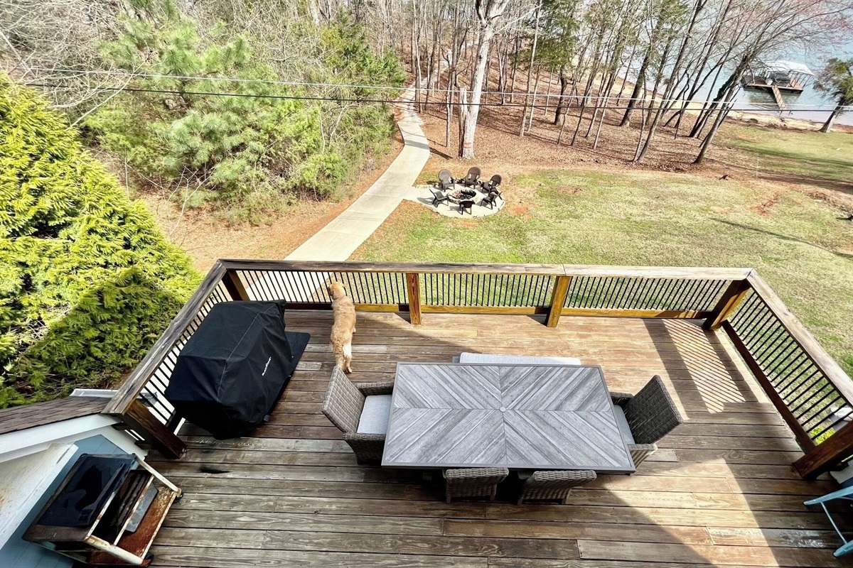 Deck with view of the water, firepit and pathway to the dock