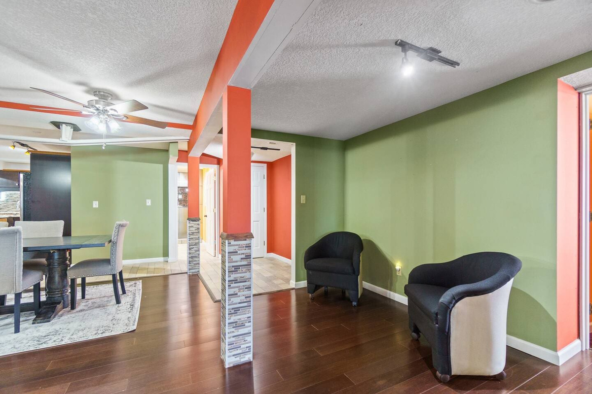Dining area with two single couches at the back, offering a cozy and stylish space for both dining and relaxation.