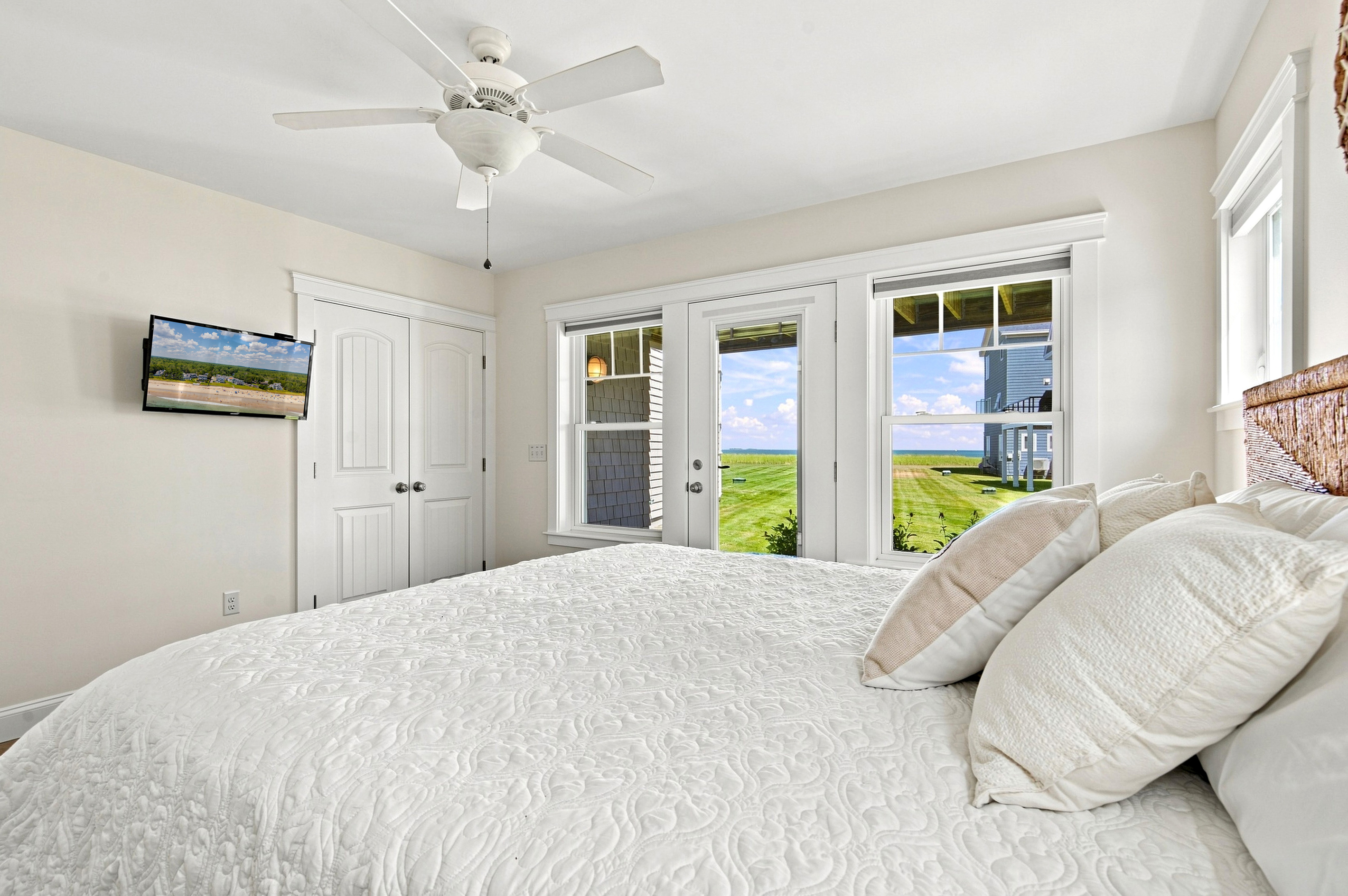 Wake up to sunshine and peaceful coastal scenery from this spacious, light-filled bedroom.