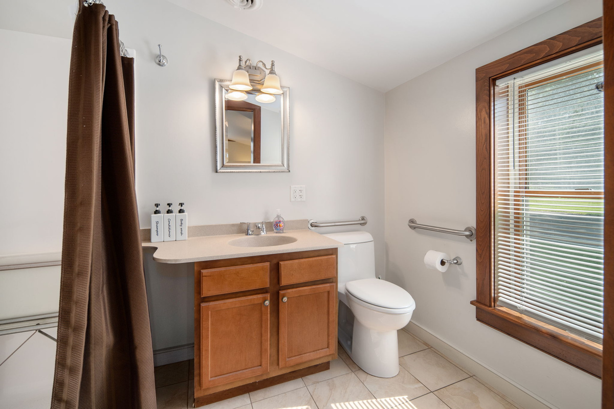 Natural light brightens the bathroom's vanity and shower area.