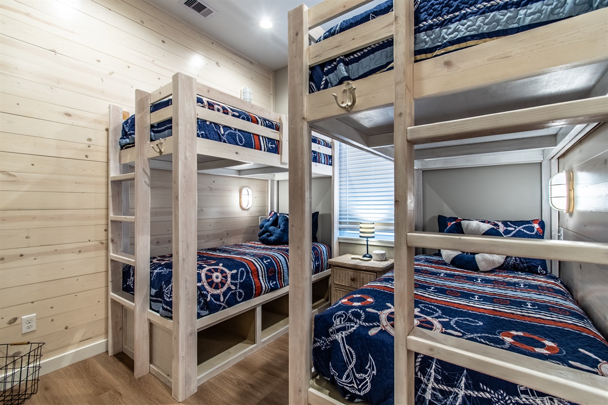 2 bunk bed sets (4 total twins in this space) with sound machine and a plug/reading light by each bedside