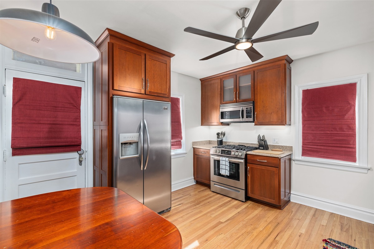 Kitchen with gas range, microwave, dishwasher, full kitchen utensils, plates, bowls, (kids cups and dishes), toaster, blender, waffle maker, and cookware.  Additional dining space for 4.