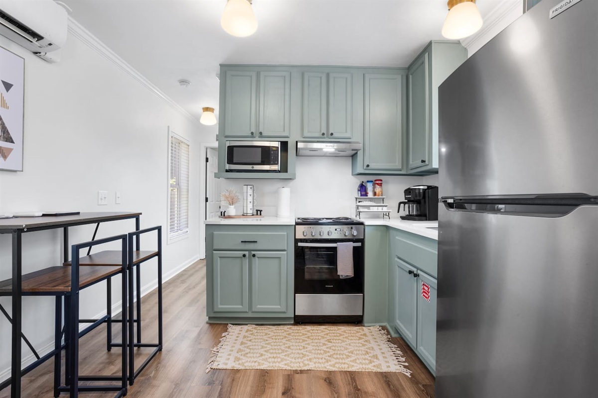 Full kitchen with refrigerator, oven, stove microwave, and coffee maker. 