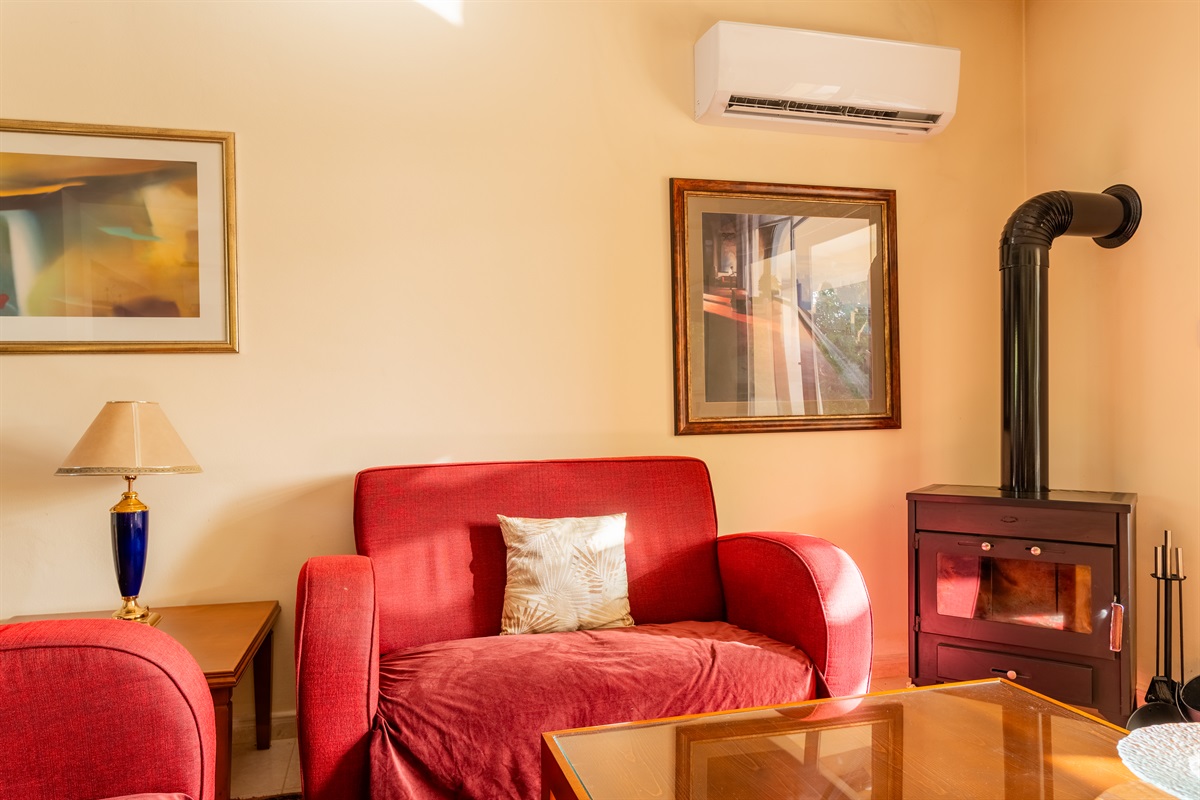 Relax in the cozy living room, complete with a wood-burning stove – perfect for adding both warmth and ambiance on winter nights.