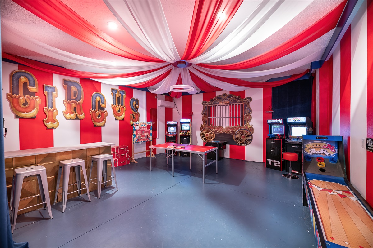 Circus Playroom: Dive into fun with arcade games, ping pong, and vibrant circus-themed decor!