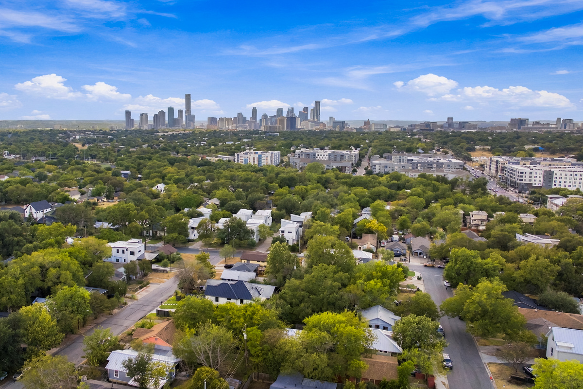 Aerial view captures the downtown Austin skyline just beyond the neighborhood.