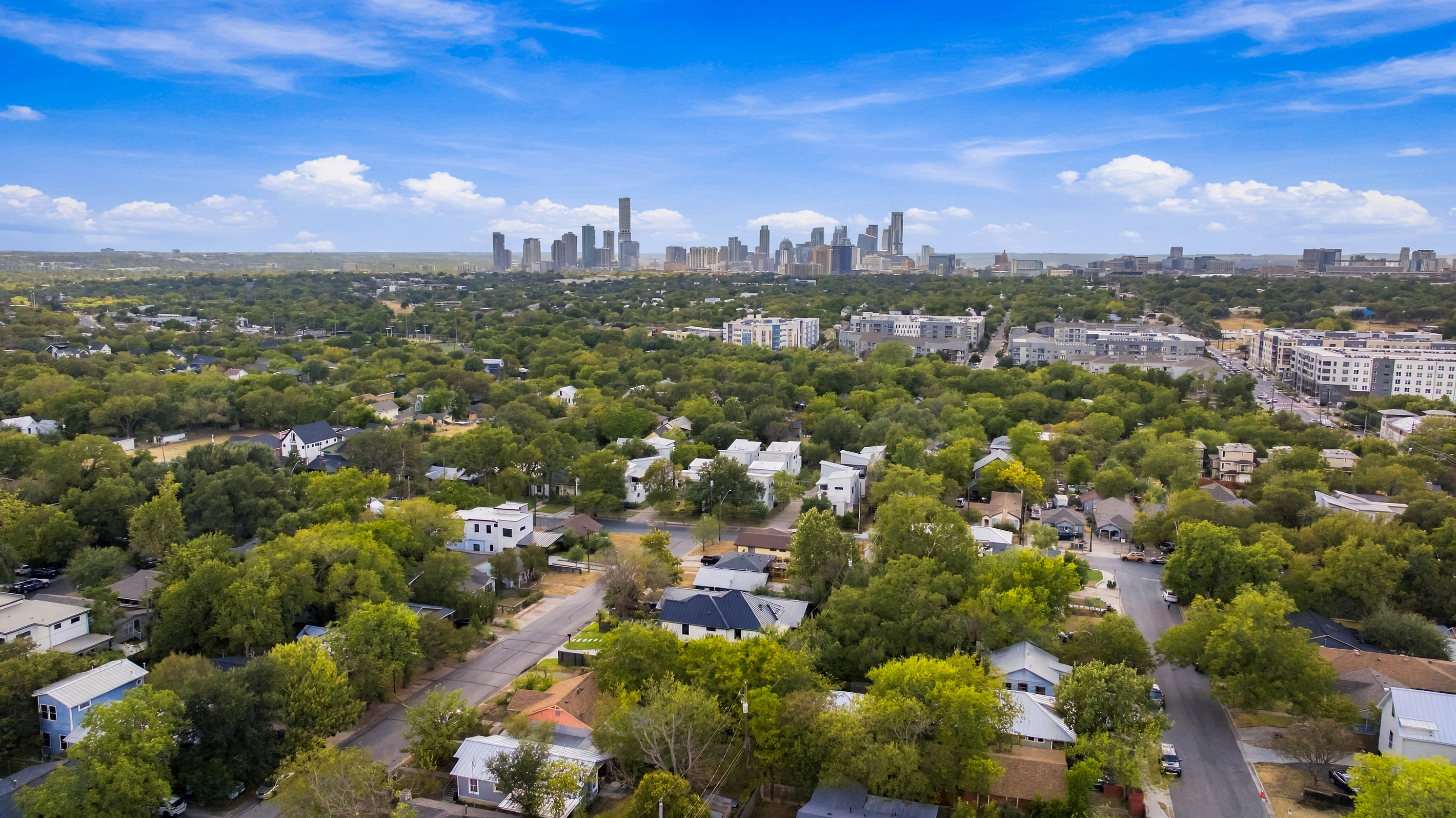 Aerial view captures the downtown Austin skyline just beyond the neighborhood.