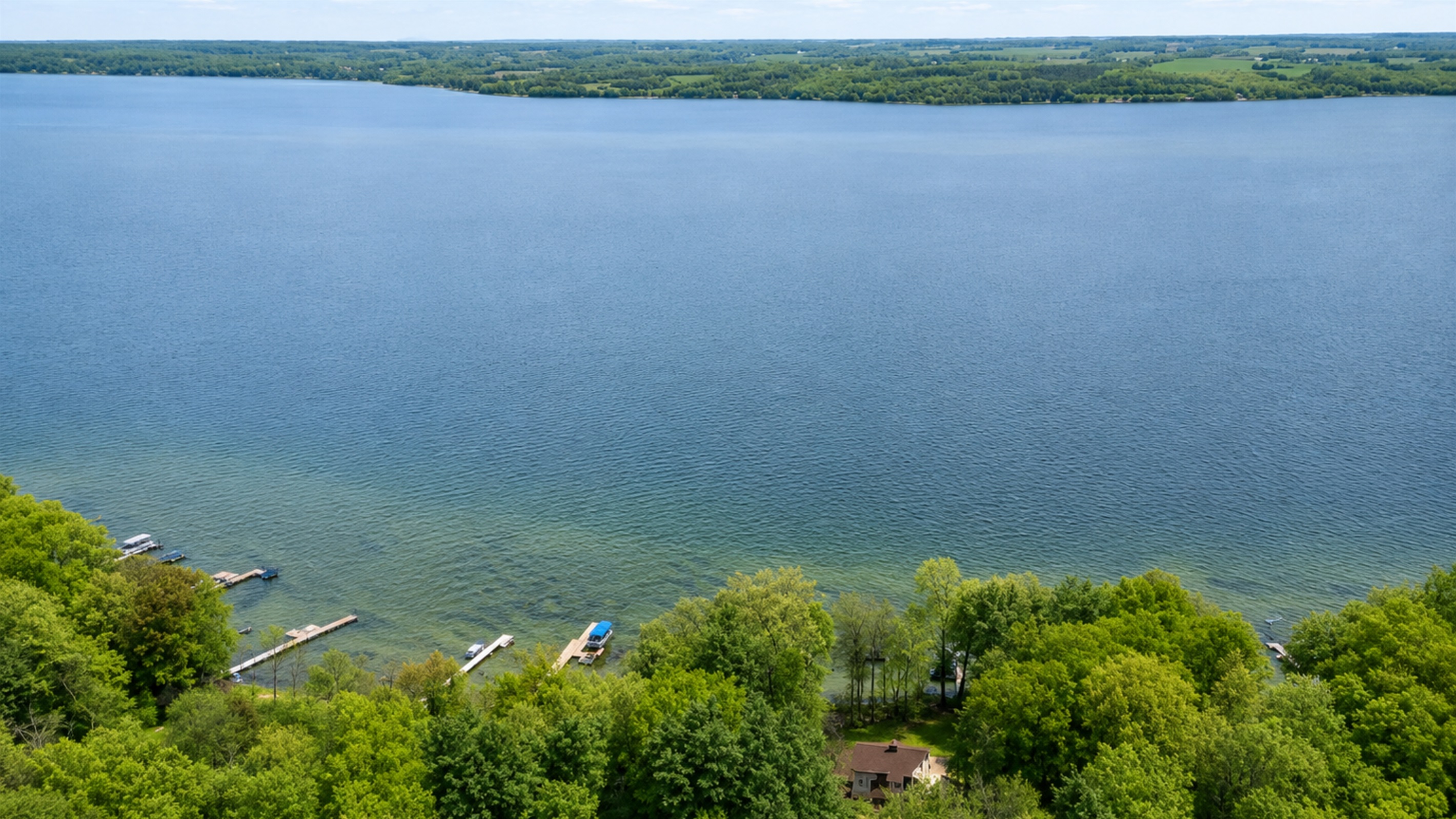 Soaring aerial reveals endless Cayuga Lake vistas and our secluded lakefront hideaway nestled in lush Finger Lakes trees—privacy with a panorama 🌊🌲✨