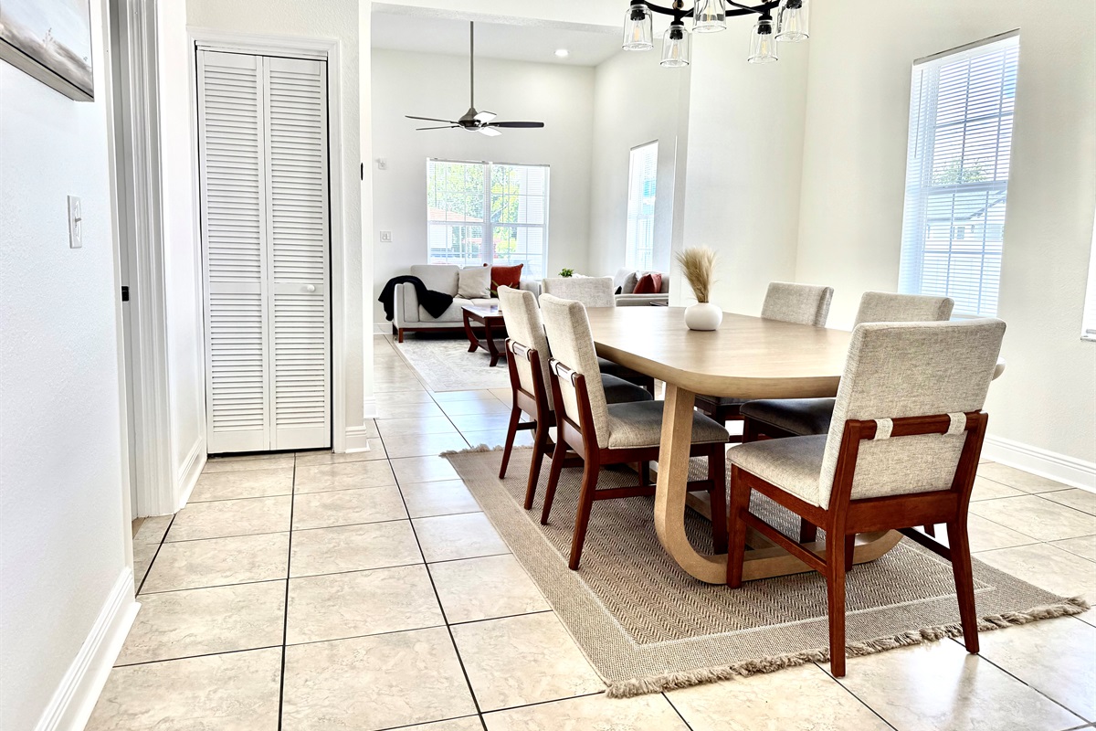 Comfort meets elegance in this dining area, where soft neutral tones and a statement light fixture create the perfect mood for every meal.