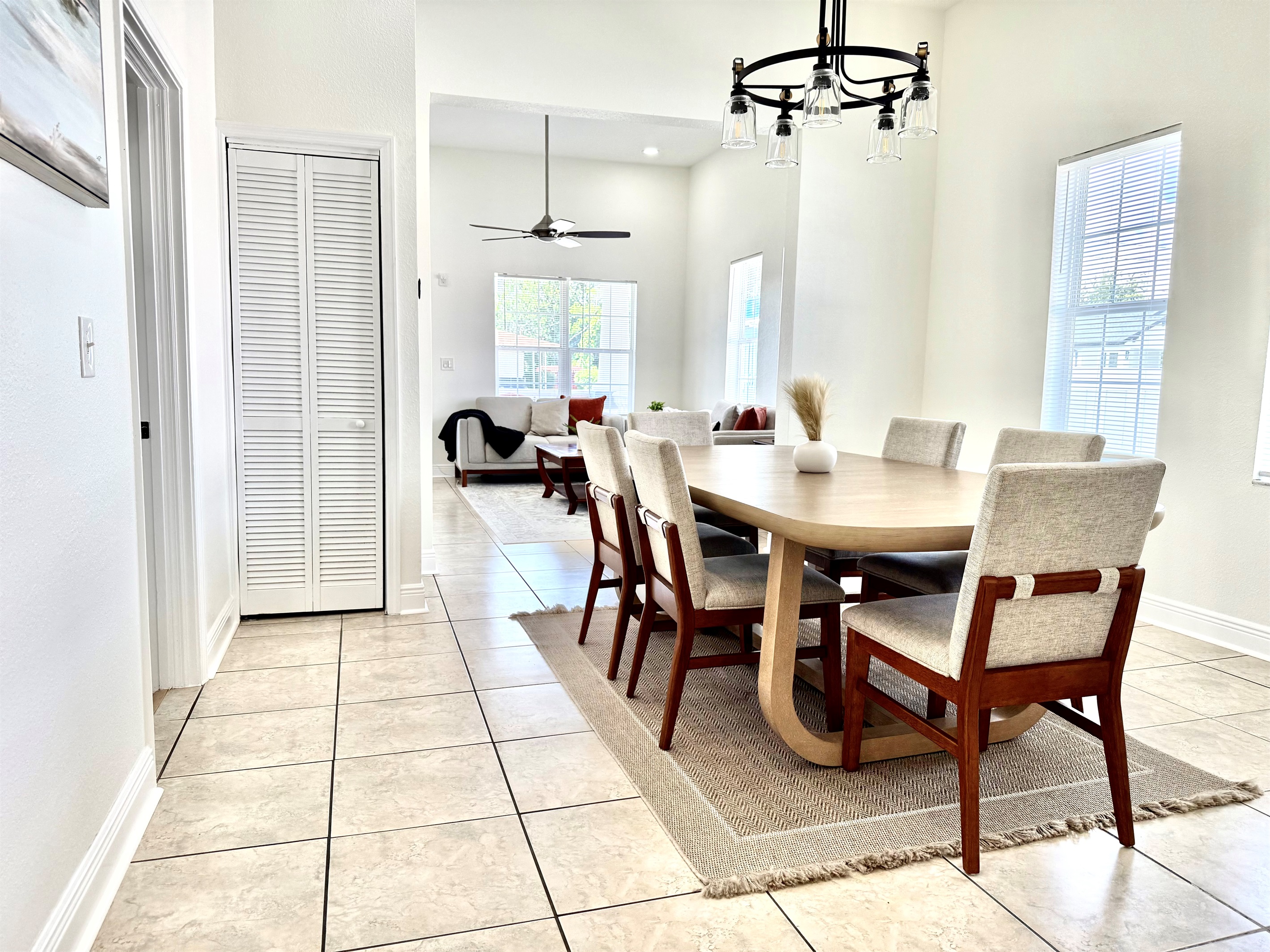 Comfort meets elegance in this dining area, where soft neutral tones and a statement light fixture create the perfect mood for every meal.