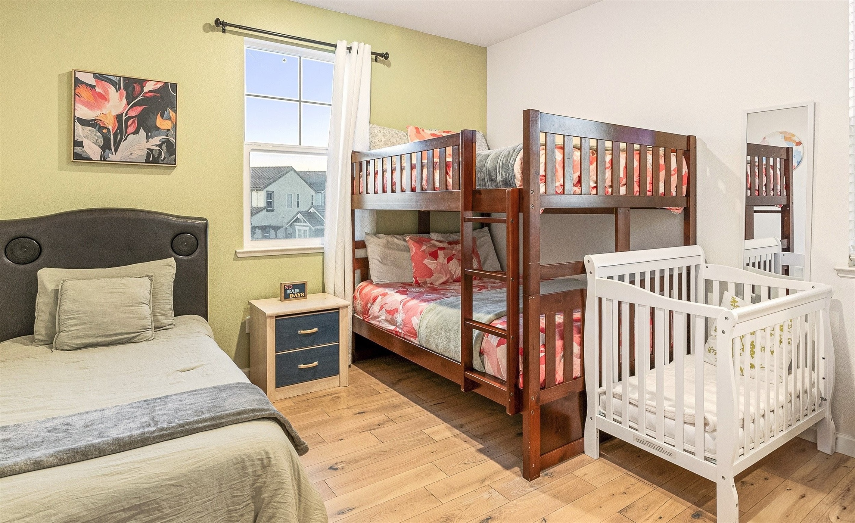 Kid-friendly room with bunk bed, twin bed, and crib—perfect for families