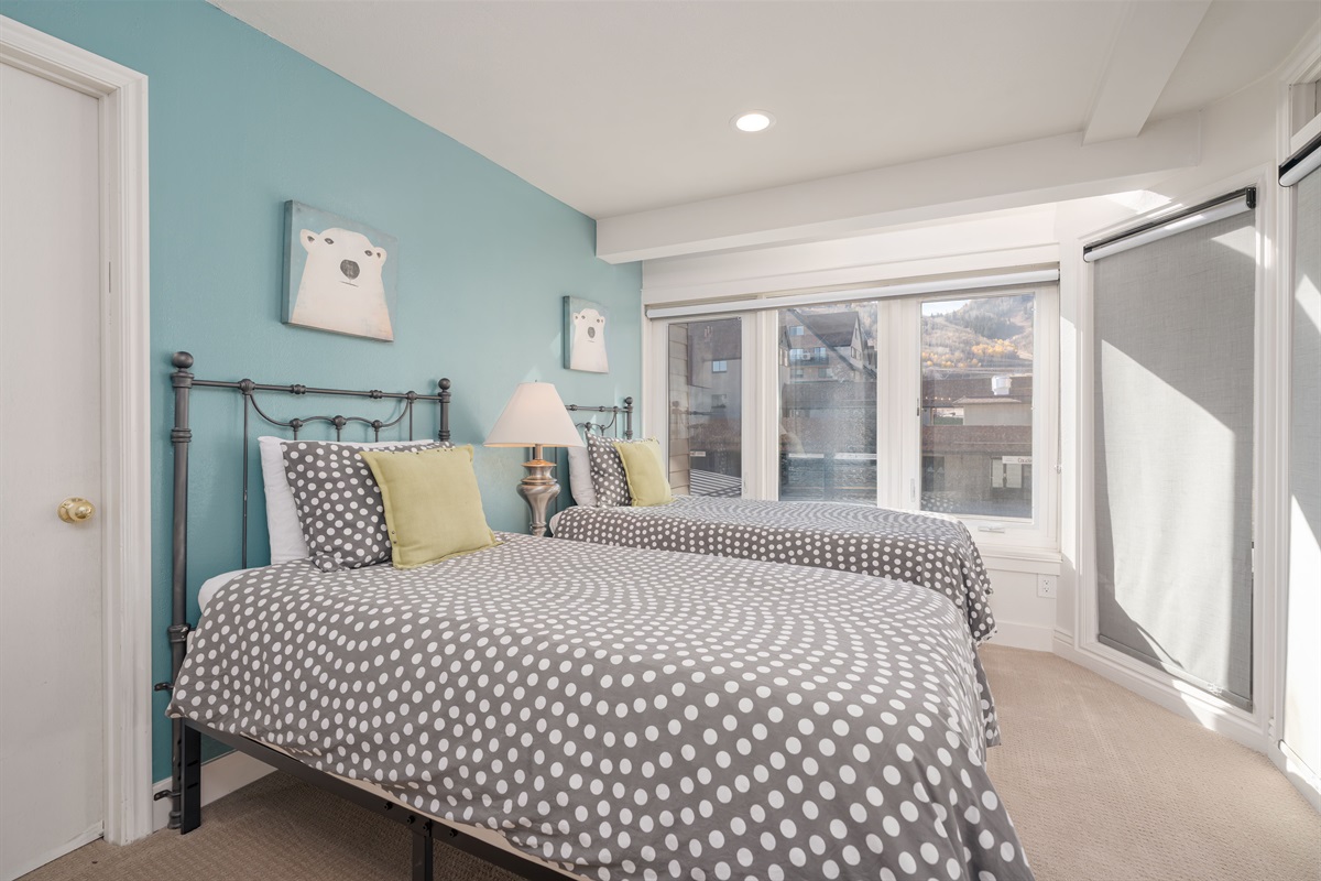 Bedroom 2. Twin beds overlooking the ice rink below. Separate walk in closet.