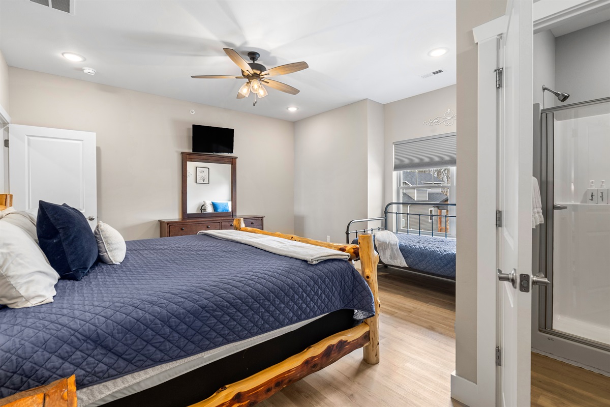 Upper level King bedroom 6 with twin bed and private en-suite shower shower .