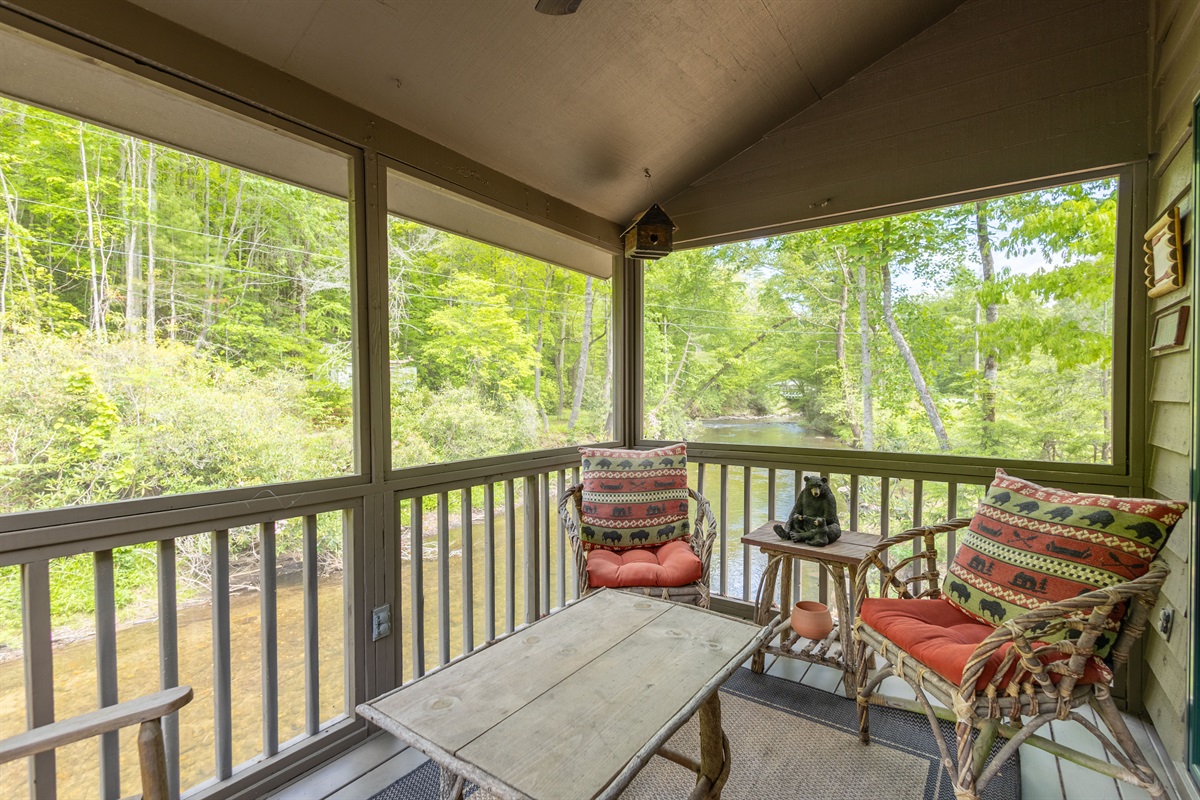 The screened-in porch offers a peaceful place to relax while enjoying the sights and sounds of Snowbird Creek without worrying about the elements.