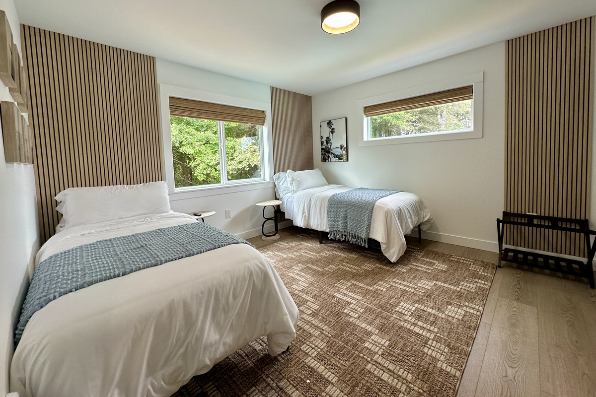 Tuck the kids in here with their own twin xl beds and a nightstand between them — simple, quiet, and steps from everyone else. Or join them together for another king bed.