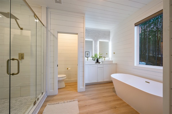 Crisp white shiplap walls and warm wood floors blend modern design with cabin charm.