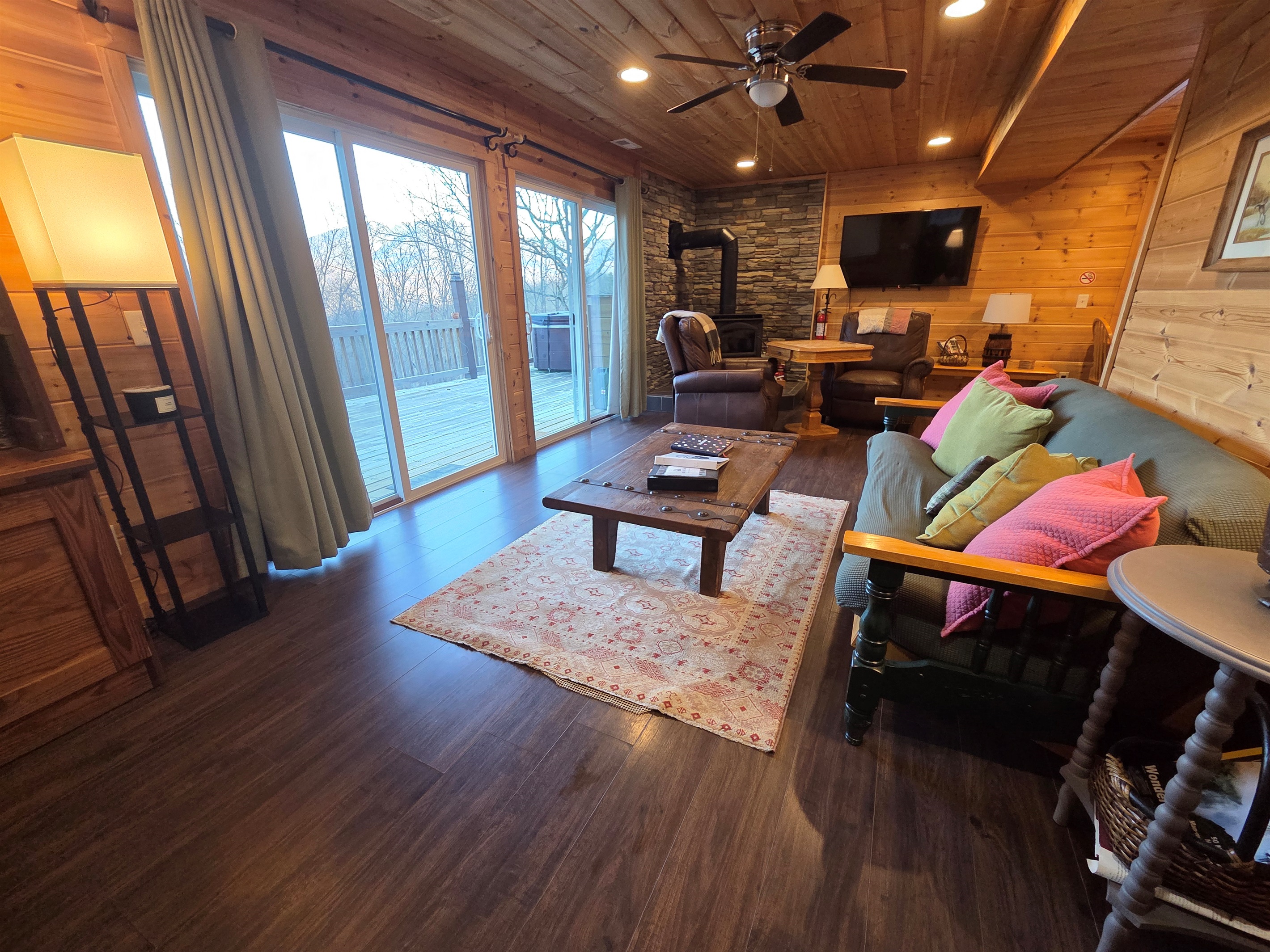 Relax in the spacious, cozy, and rustic living room, complete with a wood-burning fireplace and stunning views.