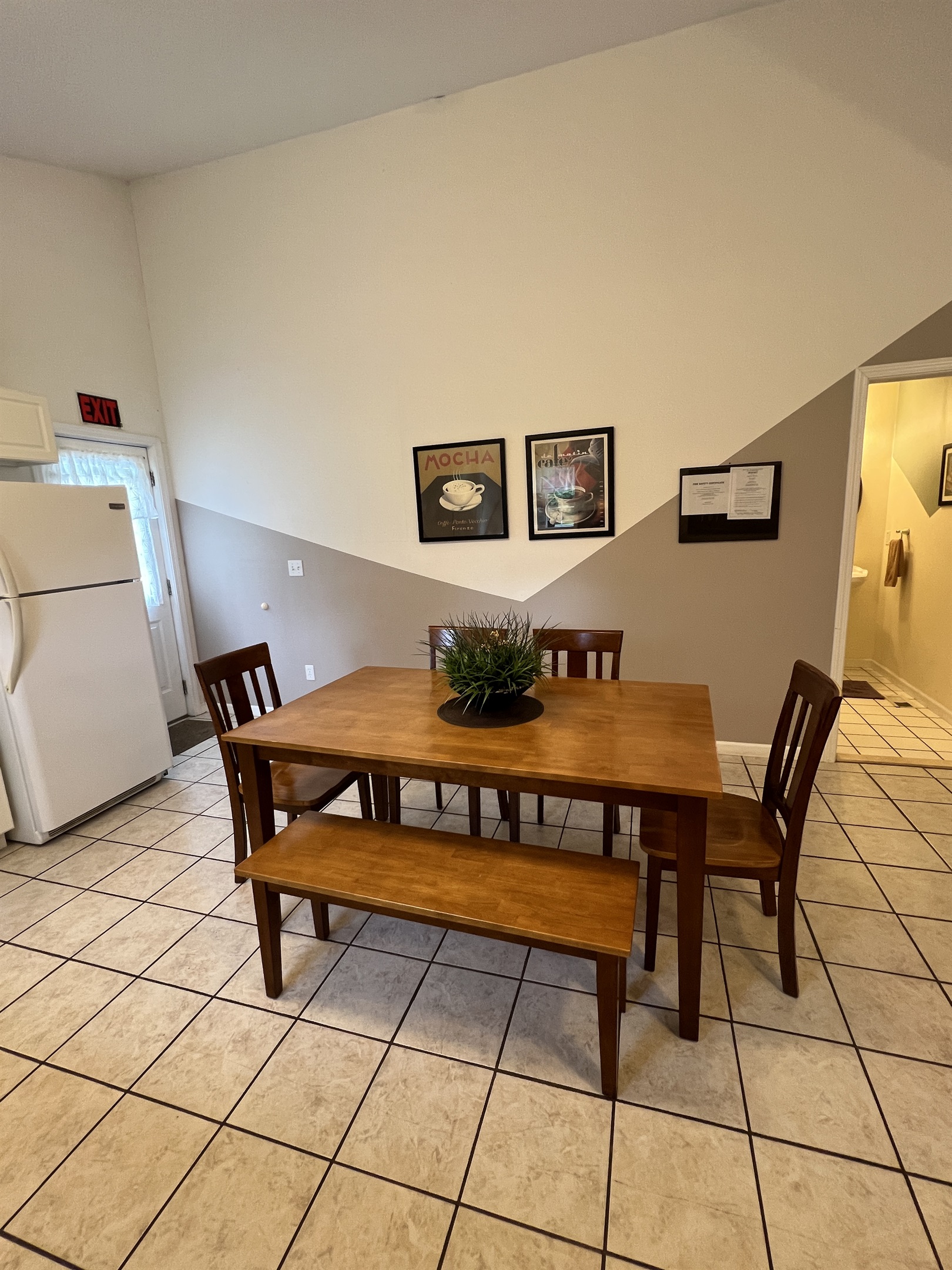The Federal House Apartment 1 dining  table with seating for six. The exit door on the  left leads to the back deck and grill area.