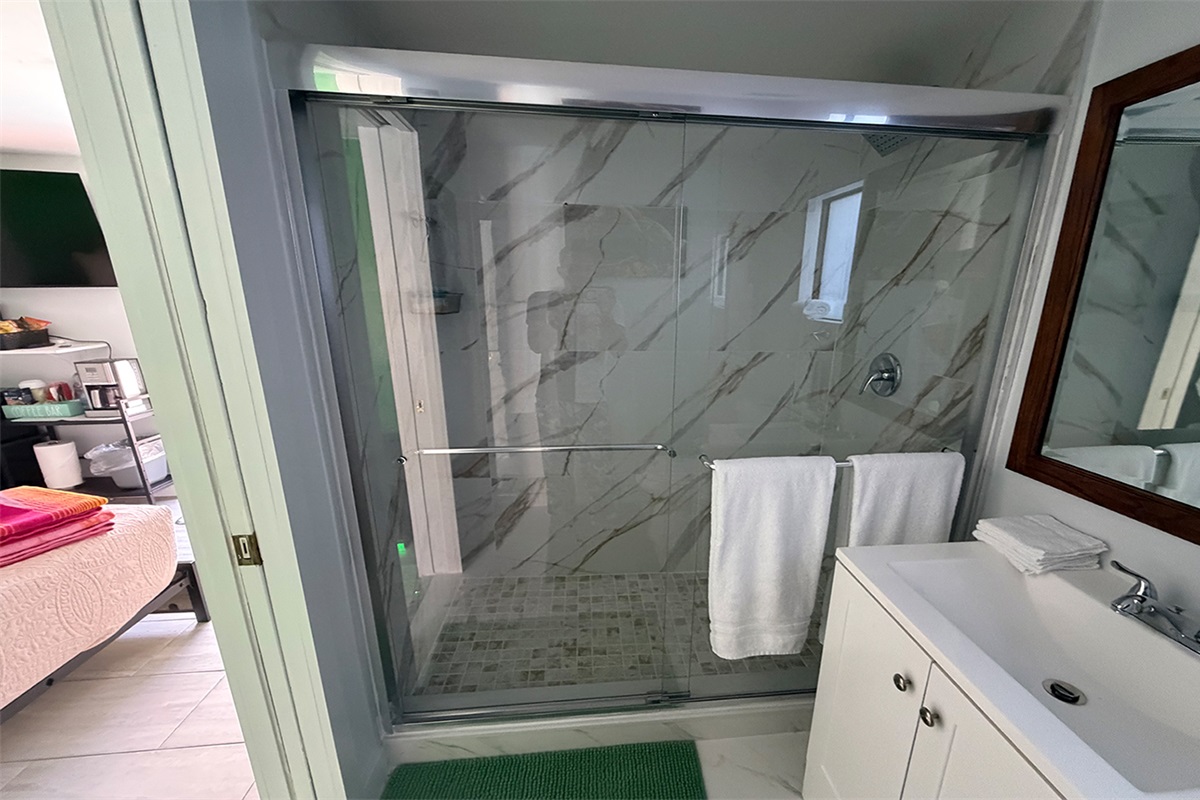 Clean, modern bathroom with walk-in shower and fresh linens.