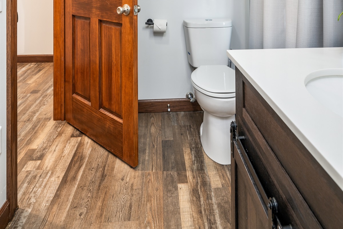 Clean, well-kept bathroom featuring fresh towels, a full vanity, and everything you need to start your day refreshed.
