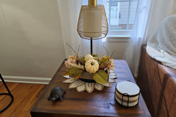 Pumpkin spice vibes, anyone? Our side tables are dressed for fall with cozy decor, plenty of coasters, and mood-setting lamps that double as phone chargers—because ambiance and convenience go hand in hand.