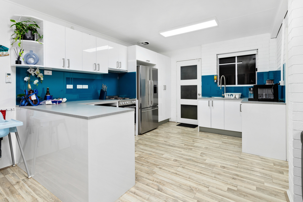A second kitchen downstairs adds flexibility at Skye’s Beach House, with fridge, sink and bench space beside the lower living area.