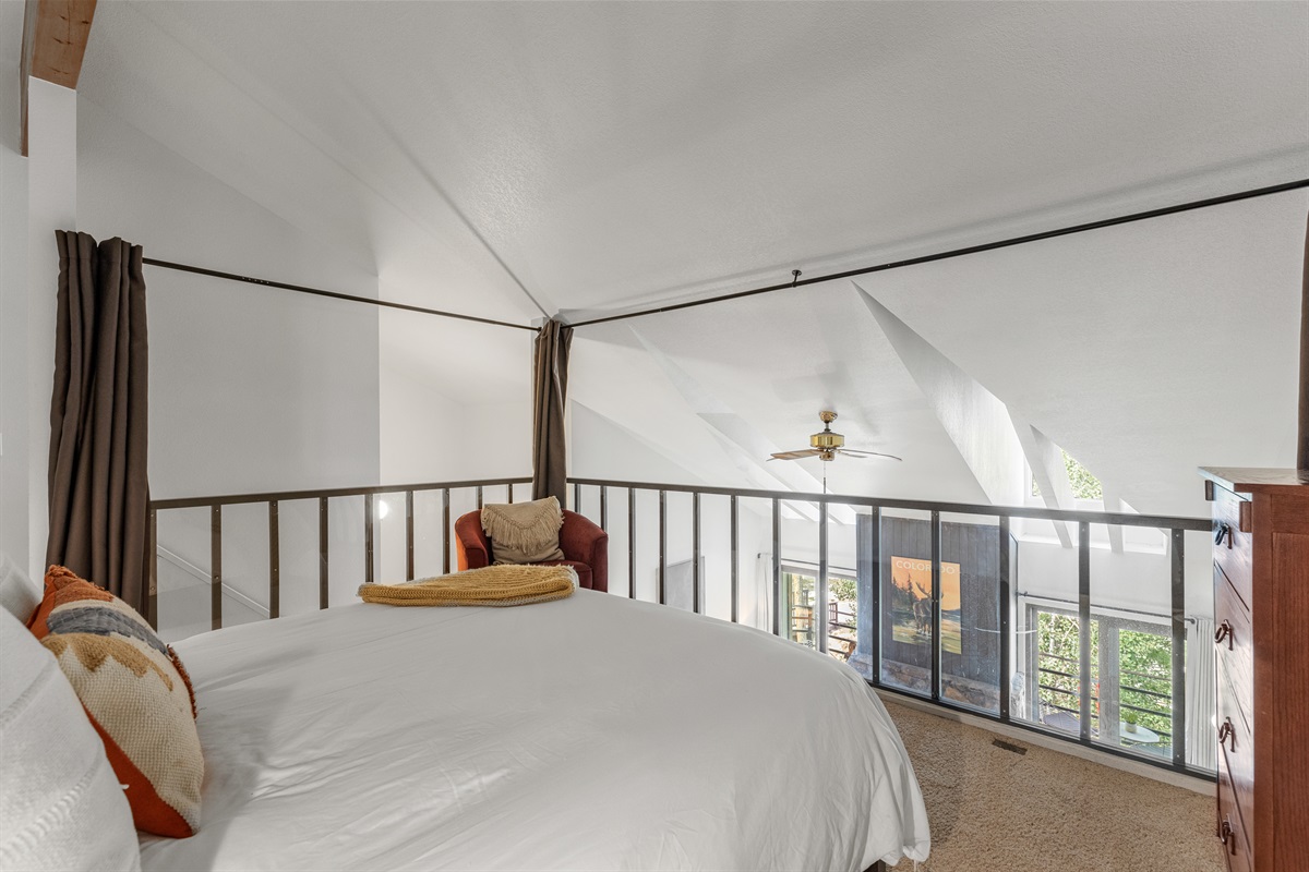 Loft with queen bed and curtains for light and privacy