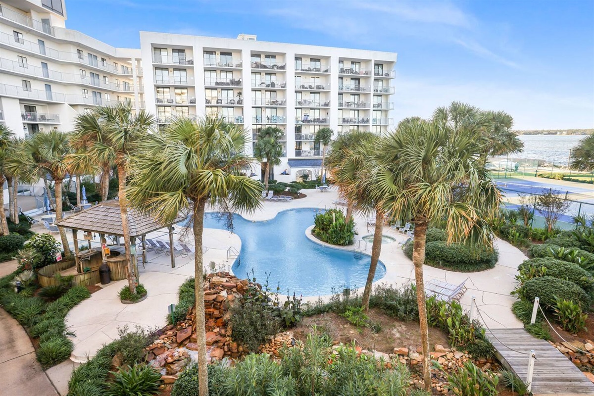 An amazing pool with scenic palm trees and a bubbling waterfall, offering stunning bay views. Enjoy onsite restrooms for added convenience—no need to leave the poolside.