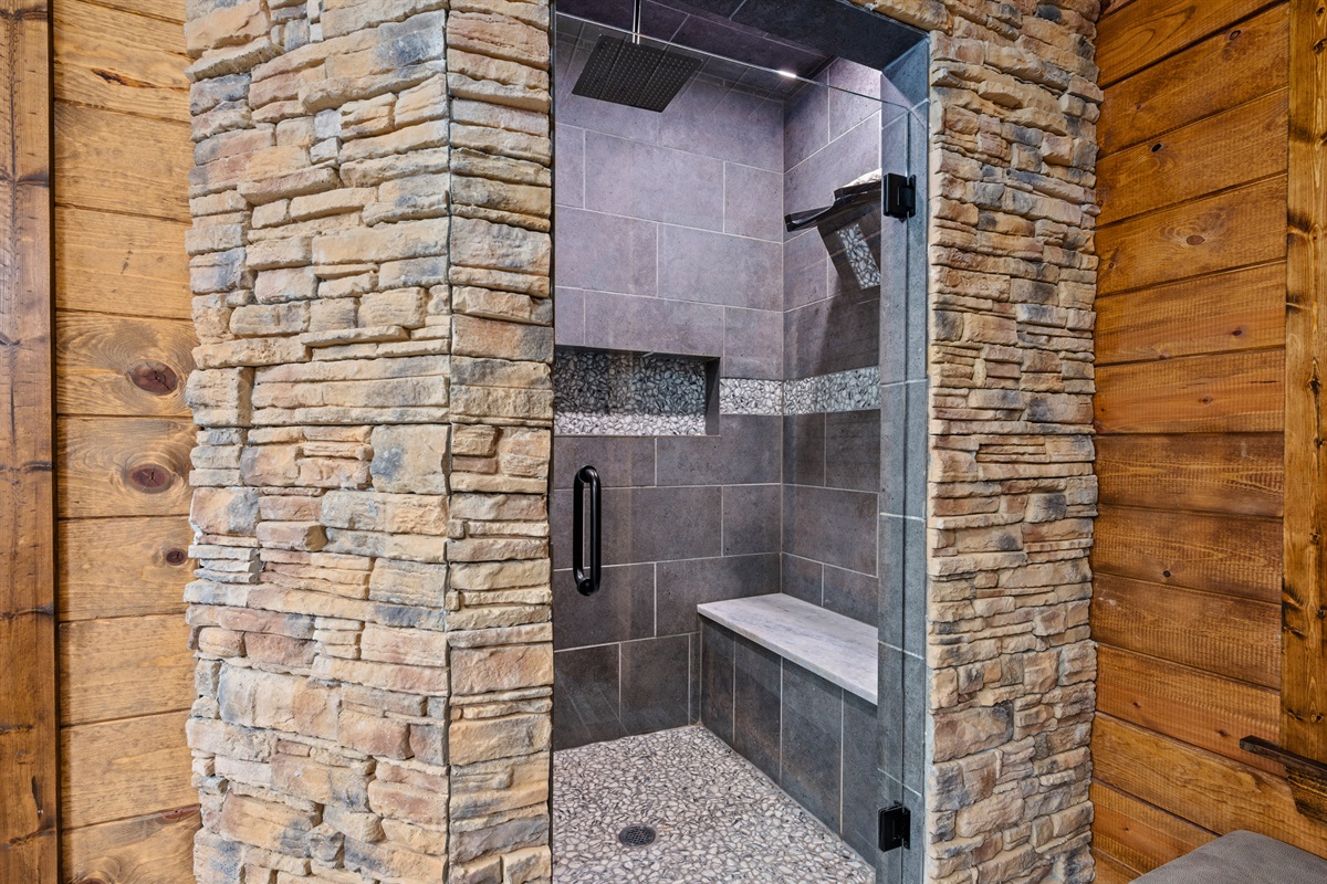 The walk-in shower showcases sleek tile work and a spacious design for a refreshing start or end to your day.