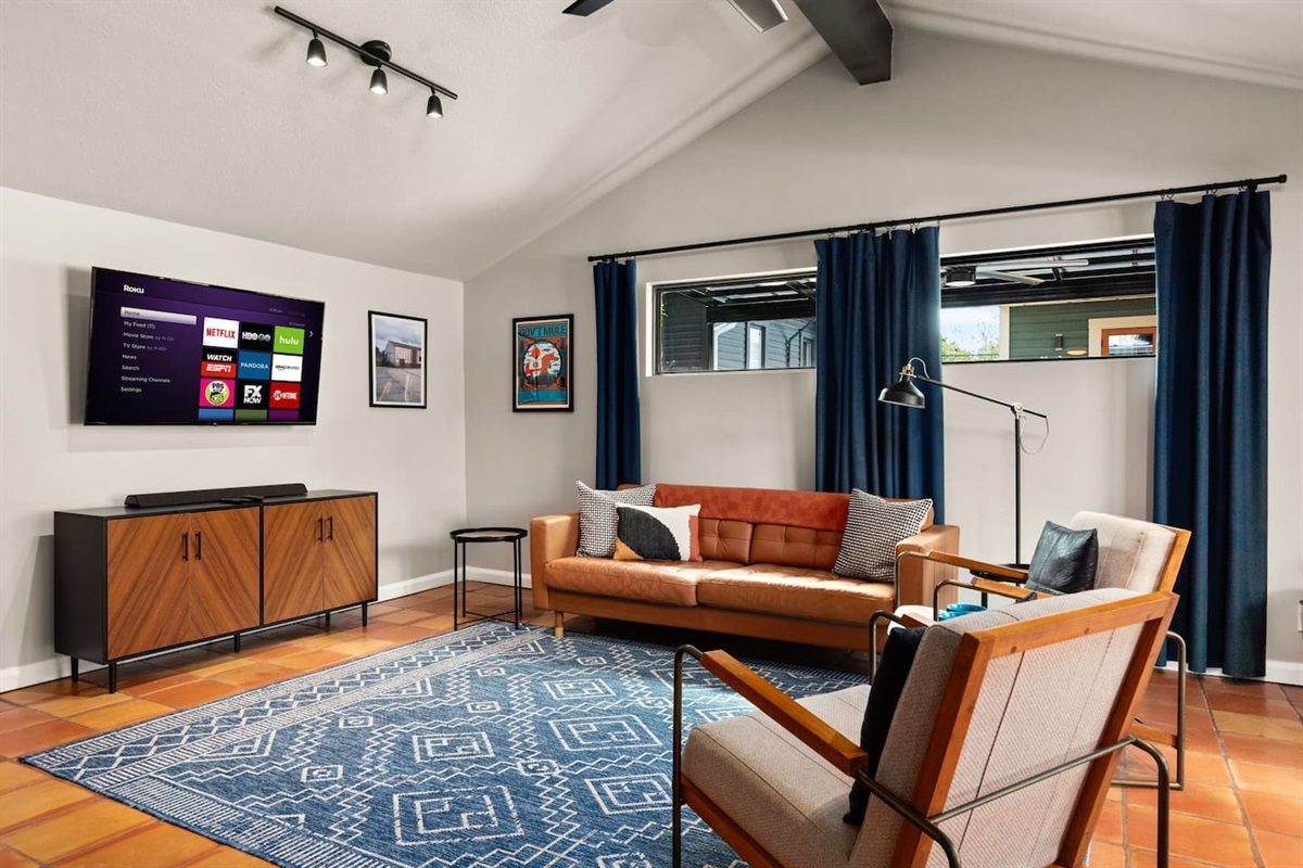 Living area: Love seat, couch, and 50 inch Smart TV with DVD player