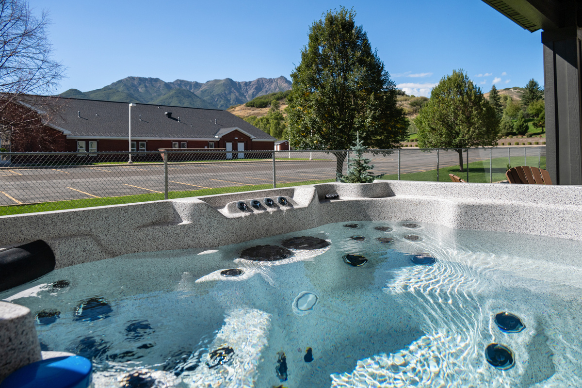 Unwind in the private hot tub while taking in the open surroundings and nearby mountain scenery.