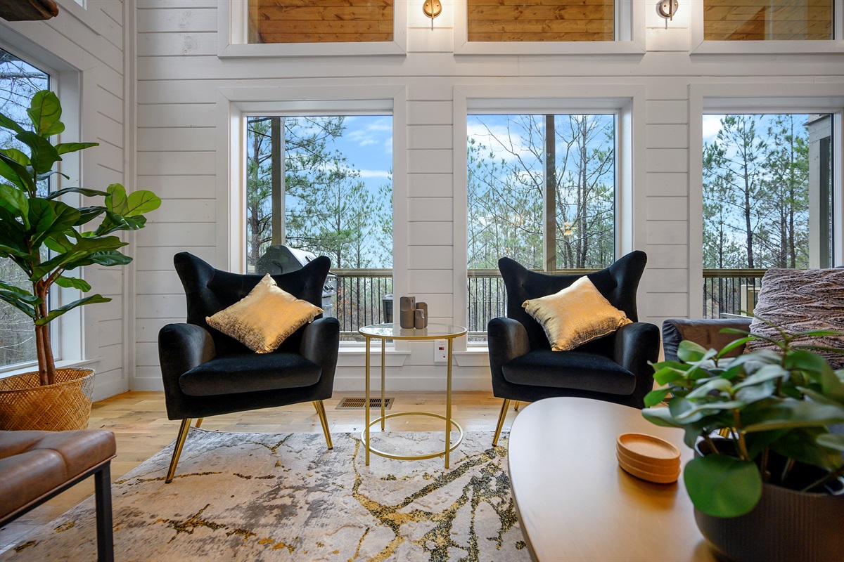 Comfortable central lounge made for downtime, featuring seating, fireplace, and screen.