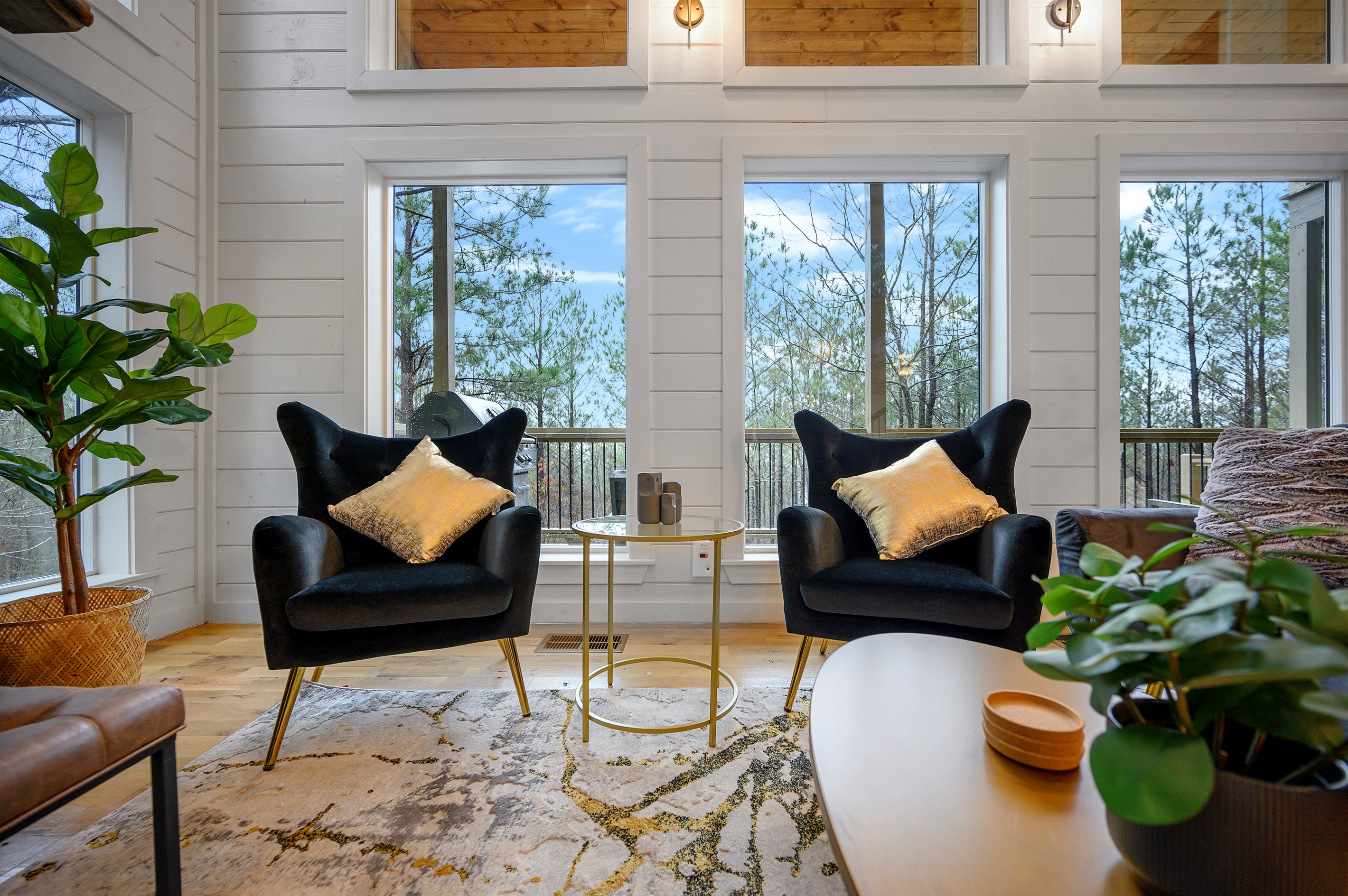 Comfortable central lounge made for downtime, featuring seating, fireplace, and screen.